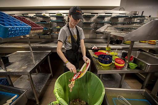 kitchen staff removing food off plates