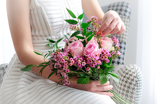 woman holding bouquet of flowers