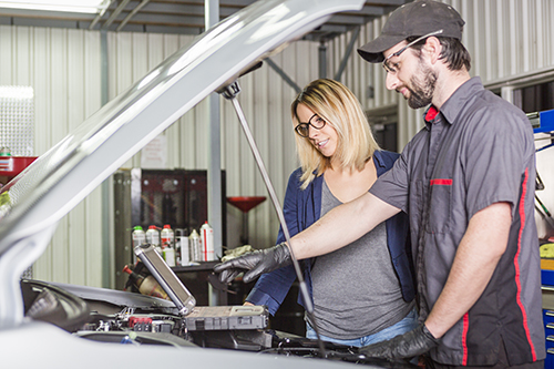 auto mechanic auto mechanic and female customer in garage