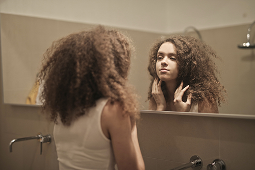 Woman looking into the mirror