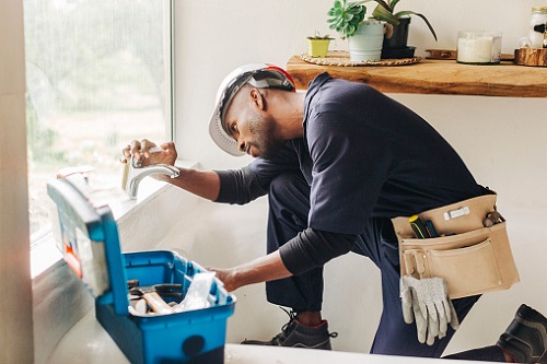 Plumber fixing a faucet