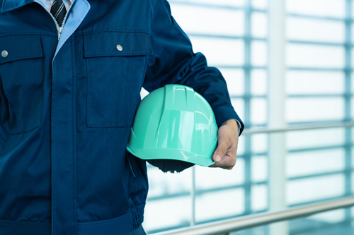 May 1-Emergency Preparedness_Blog Image Business owner holding safety hard hat