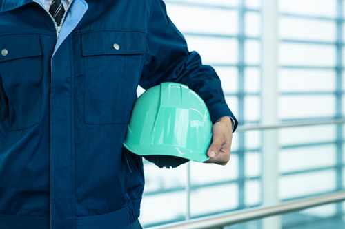 Business owner holding safety hard hat