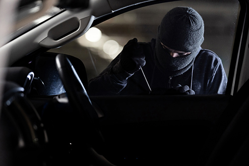 vehicle-break-in Thief breaking in vehicle