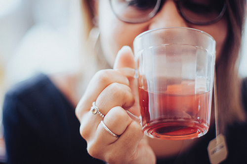 employee holding hot tea