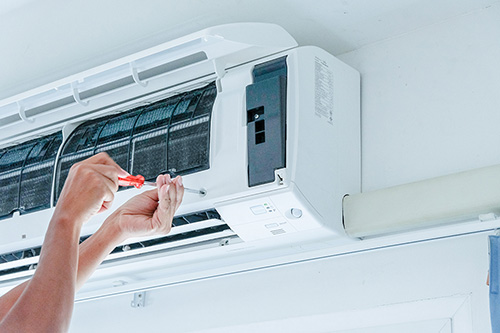 Air conditioner repairing by technician Air conditioner damage