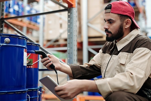 ContractorBuyingMaterials A contractor inspecting materials at a hardware warehouse