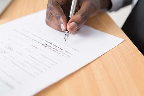 A man signing a customer liability waiver
