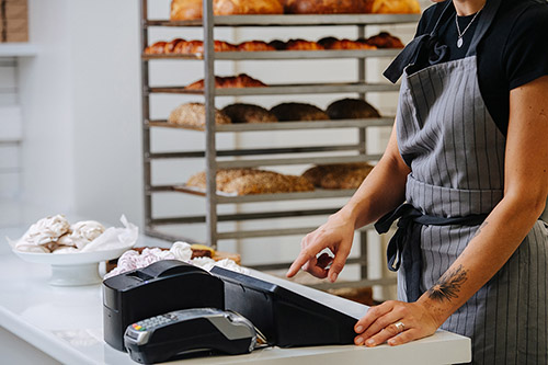 bakery shop owner at the cash till
