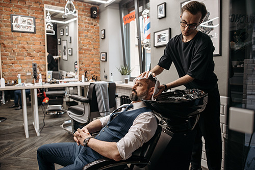 customer sitting on barber chair