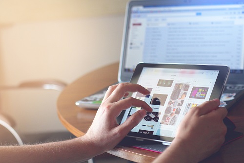 A woman shopping online with a tablet computer