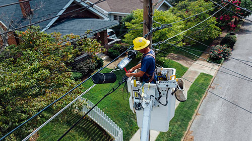 electrical contractor working on hydro pole
