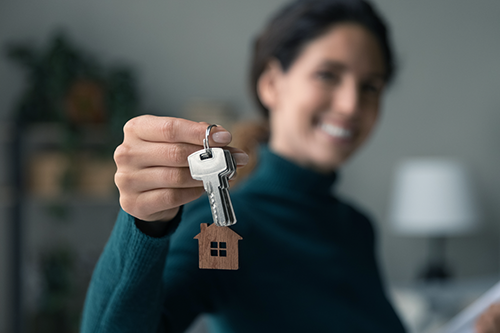 A woman with keys to a house.