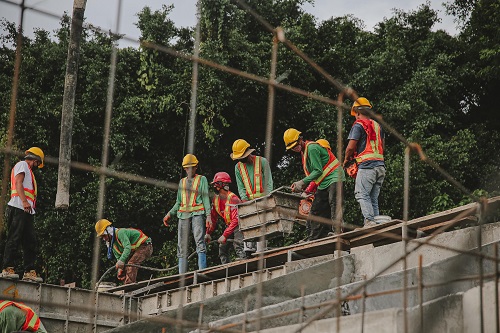 A group of construction workers at a large job site