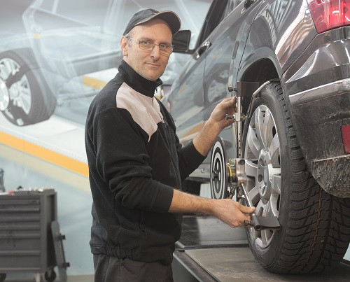 An auto repair technician working on a vehicle