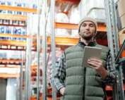 A business owner conducting an inspection of a warehouse