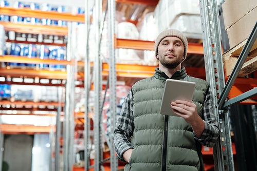 A business owner conducting an inspection of a warehouse