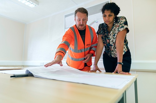 A general contractor discussing plans with a customer.