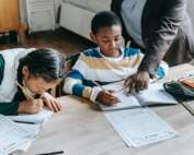 A tutor assisting a young student.