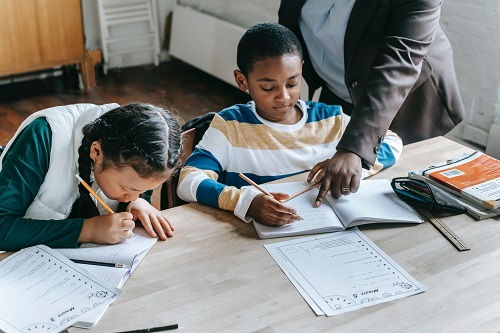 A tutor assisting a young student.