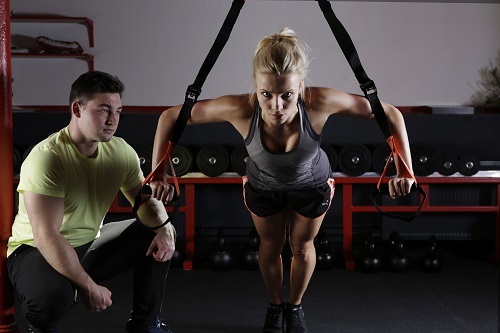 A personal trainer working with a client.