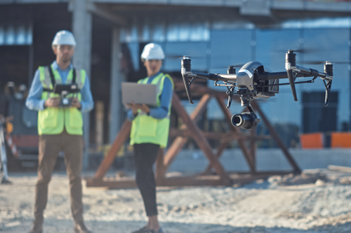 A survey crew launching a drone.