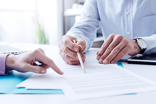 A small business owner signing a contract.