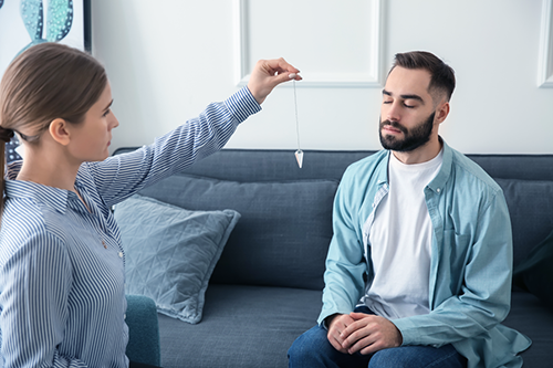 A hypnotherapist treating a client.