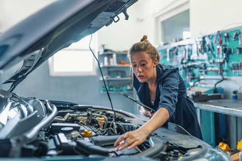 An auto technician working on a vehicle.