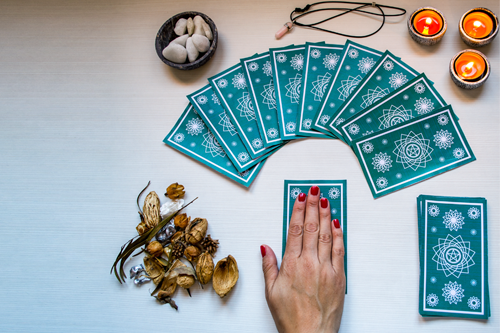 A tarot card reader preparing to serve a customer.