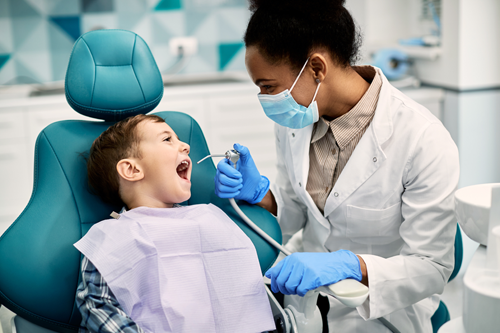 A dental hygienist with a young patient.