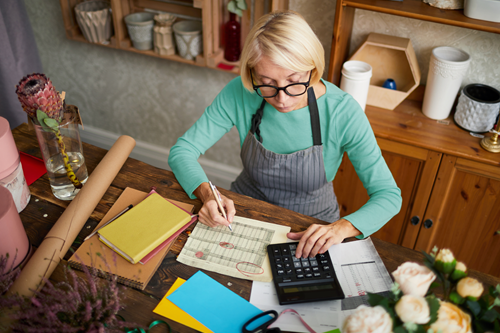 A small business owner calculating her annual revenue.