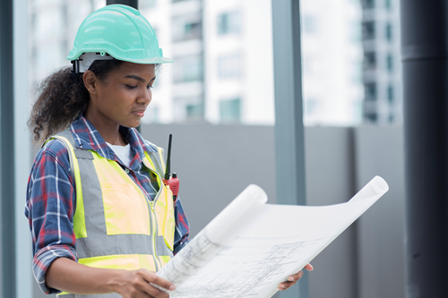 A contractor reviewing a blueprint.