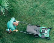 A landscaper mowing a client's lawn.